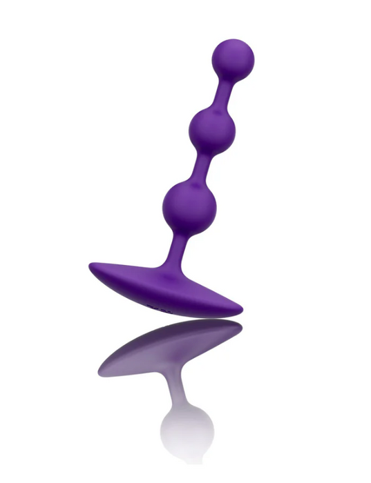 Purple silicone butt plug on a white background