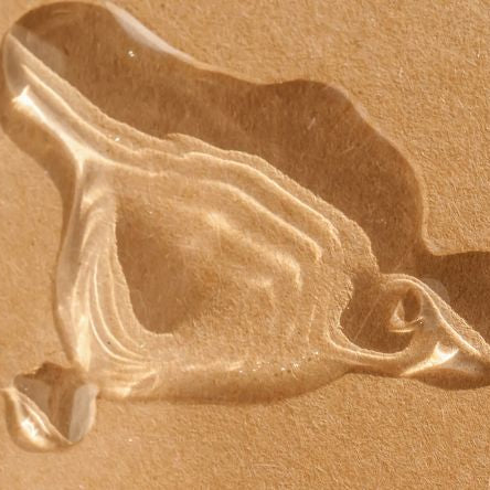 lubricant drop on a beige background